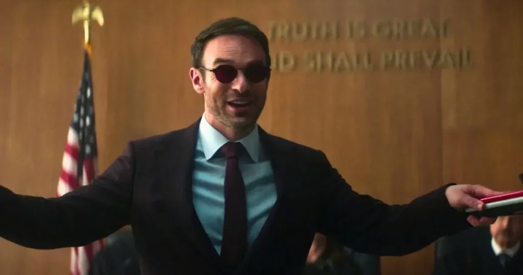 Daredevil Born Again Season 2 Ending Explained: Why The Prison Cell Is The Best Thing That Could Have Happened To Matt Murdock 1 Matt Murdock In Orange Prison Jumpsuit And Red Glasses Smiling In Cell In Daredevil Born Again Season 2 Finale