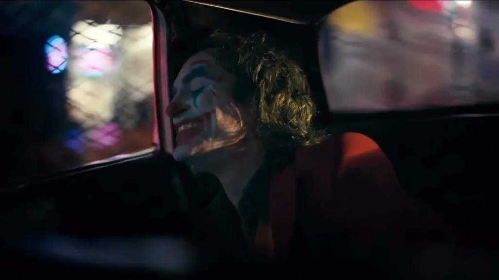 joker in police van smiling