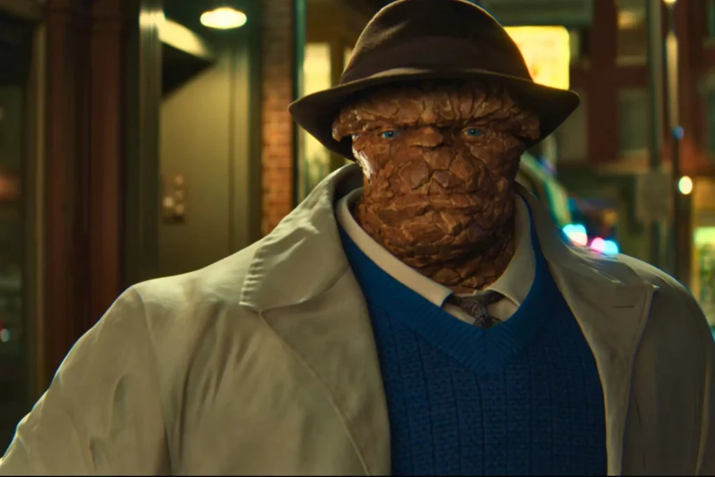 Ben Grimm/The Thing With Rocky Orange Skin Texture Wearing Fedora Hat, Tan Coat And Blue Sweater Vest In The Fantastic Four: First Steps