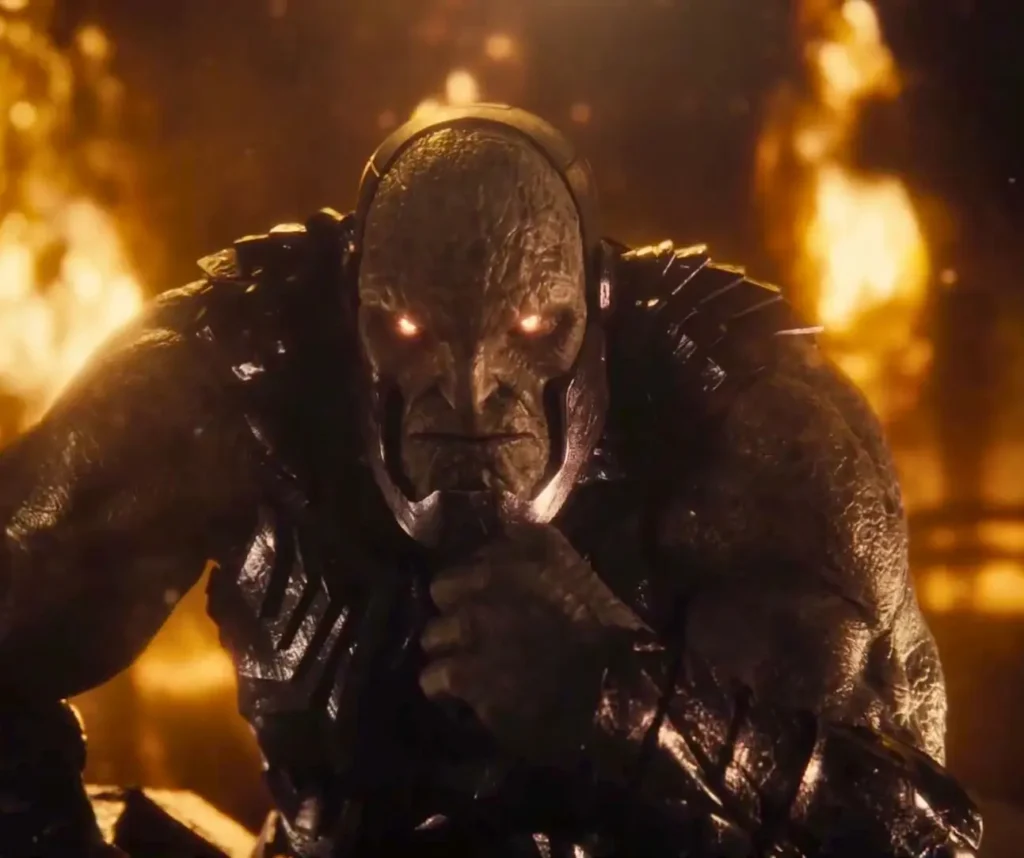 Darkseid in aggressive charging pose with glowing eyes surrounded by flames and smoke