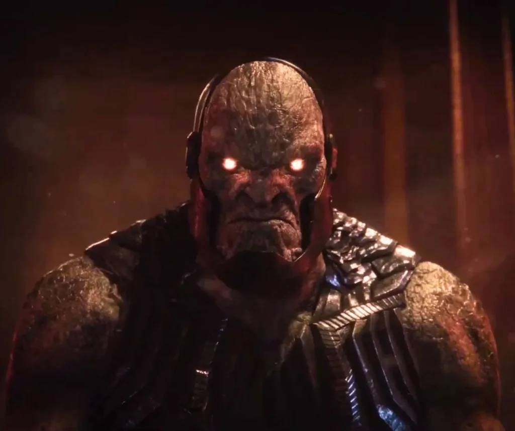 Close-up of Darkseid's craggy stone-textured face with glowing red Omega eyes and metallic armor