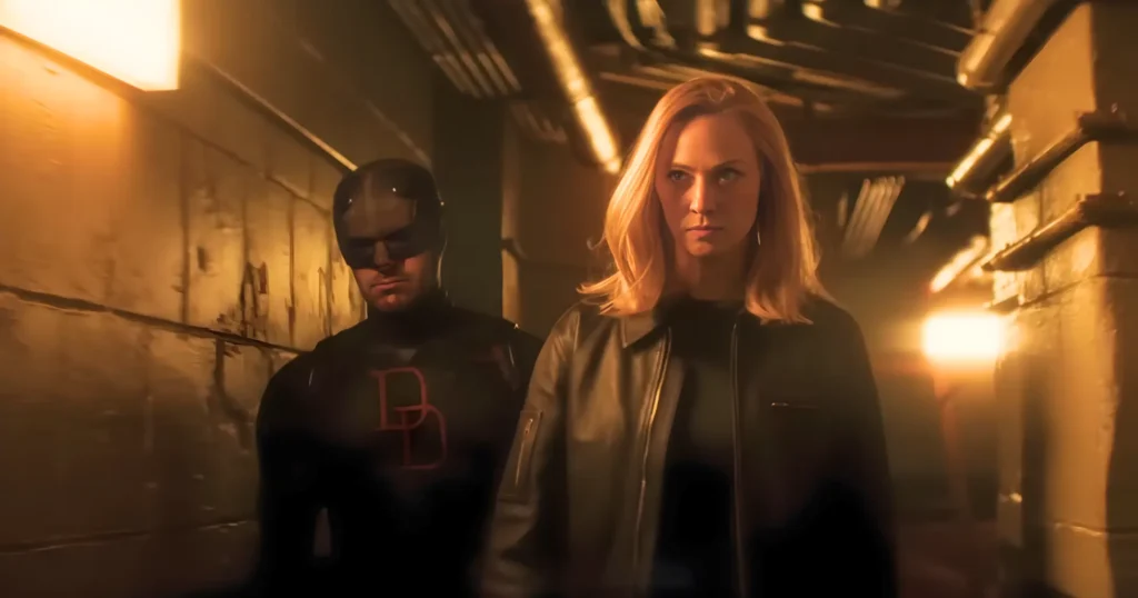 Daredevil Born Again Season 2: Everything You Need To Know Before March 24 4 Daredevil In Black Suit With Dd Emblem And Karen Page Walking Through A Dark Underground Corridor In Born Again Season 2